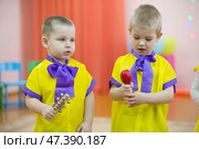 Belarus, the city of Gomel on March 2, 2018. Kindergarten for children. Children's holiday.Little children with musical instrument bells. Редакционное фото, фотограф Лазаренко Светлана / Фотобанк Лори