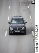 Black crossover BMW X5 aerial front view. Top view of 4WD car driving on highway road. SUV in motion. Редакционное фото, фотограф Константин Григорьев / Фотобанк Лори