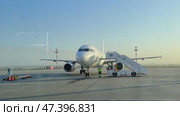 Mineralnye Vody, Russia - 09.03.2024: Passenger aircraft with boarding stairs, prepared to taking off on runway, waiting for boarding passengers, baggage before flight. Airport trip concept. Footage. Редакционное видео, видеограф Ирина Михайличенко / Фотобанк Лори