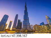 Dubai, United Arab Emirates - Jan 19 2024, panoramic view of the Burj Khalifa Tower from below, at nighttime with illumination and street lights, Dubai, UAE. Редакционное фото, фотограф Сергей Богомяко / Фотобанк Лори