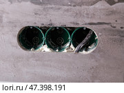 Three electrical boxes for conduits are built into the wall. Work on installing electrical outlets. Стоковое фото, фотограф Виктория Тельминова / Фотобанк Лори