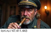 Man in Military Uniform Smokes Cigar While Seated Indoors in Rustic Setting During Evening Time. Стоковое AI-изображение, AI-художник Sergey Grishin / Фотобанк Лори