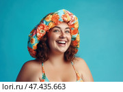 Happy woman in beach hat on blue background, chubby plus size model portrait. Стоковое AI-изображение, AI-художник Станислав Тарко / Фотобанк Лори