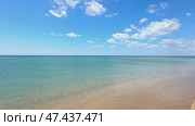 Sunny beach with a turquoise ocean in the background. Sea waves near the tropical coast on a sunny day. Cruise. Landscape of a summer sea beach with white sand and shells. Travel concept footage. Стоковое видео, видеограф Ирина Михайличенко / Фотобанк Лори