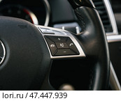 Novosibirsk, Russia -  March  23, 2024: Mercedes-Benz GL-class,  Close up of car steering wheel with function buttons. Стоковое фото, фотограф Виталий Сова / Фотобанк Лори