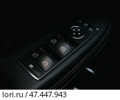 Novosibirsk, Russia -  March  23, 2024: Mercedes-Benz GL-class, Close up of a door control panel in a new modern car. Arm rest with window control panel, door lock button, and mirror control. Стоковое фото, фотограф Виталий Сова / Фотобанк Лори