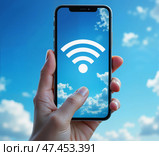 Рука с телефоном, показывающим символ Wi-Fi, на фоне неба с облаками. Стоковое AI-изображение, AI-художник Валерий Лукин / Фотобанк Лори