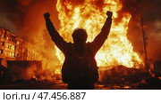 A man with his arms raised, standing with his back to the viewer in front of a giant flame. A huge column of fire engulfs a building or ruins, blazing against the backdrop of a night or twilight city. The silhouette of the man looks determined, as if he is celebrating, fighting, or demonstrating strength in extreme circumstances. The atmosphere is dramatic, filled with fire, smoke, and the energy of rebellion, protest, or survival.This scene can be interpreted as a symbol of victory, chaos, revolution, apocalypse, or fortitude. Стоковое AI-изображение, AI-художник Анна Кривицкая / Фотобанк Лори