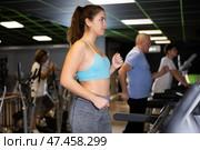 Woman riding cardiovascular trainers in gym. Стоковое фото, фотограф Яков Филимонов / Фотобанк Лори