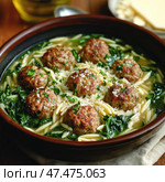 A close-up of a mouth-watering bowl of Italian wedding soup. At the center of the dish are juicy meatballs, fried until golden brown. They are surrounded by orzo (or small pasta) and fresh spinach, floating in a clear broth. The soup is topped with grated Parmesan and finely chopped parsley, giving the dish additional texture and flavor. All this is served in a deep ceramic bowl, against a wooden table and a cloth napkin, creating a cozy homey atmosphere. Стоковое AI-изображение, AI-художник Анна Кривицкая / Фотобанк Лори