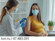 Pregnant Vaccination. Young Pregnant Woman In Face Mask Getting Vaccinated in Clinic. Doctor Giving Corona Virus Vaccine Injection to Female Patient with Belly. Covid-19 Flu Protection. Dengue fever. Стоковое AI-изображение, AI-художник Марина Демидюк / Фотобанк Лори