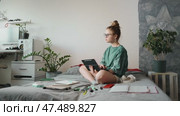 Young woman studying online course, writing down insights on tablet. Self-paced learning allows flexibility and better knowledge retention. Concept of digital education and self-improvement. Стоковое видео, видеограф Енваев Андрей / Фотобанк Лори