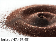 Spilled coffee grounds create a spiral galaxy pattern on a flat surface/ Вид сверху на пролитую кофейную гущу, образующую спиральную галактику, крошечные звезды разбросаны среди гранул, чистый белый фон. Стоковое AI-изображение, AI-художник Katsiaryna Repich / Фотобанк Лори