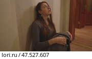 Teen Girl Slumps Against Wall Hugging Knees in Despair. Стоковое видео, видеограф Илья Шаматура / Фотобанк Лори