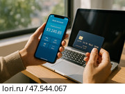 Managing Finances With a Mobile App and Credit Card at a Desk by a Window During Daylight Hours. Стоковое AI-изображение, AI-художник Юлия Гапеенко / Фотобанк Лори
