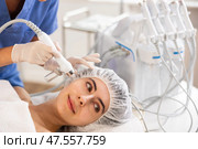 Female patient undergoing facial skin ionization procedure using ion airbrush. Стоковое фото, фотограф Яков Филимонов / Фотобанк Лори