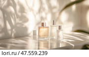 Elegant perfume bottles arranged on a surface with soft shadows cast by natural light in a tranquil setting. Стоковое AI-изображение, AI-художник Сергей Толмачёв / Фотобанк Лори