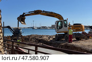 Budva,Montenegro-April 11,2025:Liebherr and Volvo excavators at a waterside. Редакционное фото, фотограф Margarita Davchenko / Фотобанк Лори