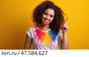 Vibrant Holi Celebration With Cheerful Woman Covered in Colorful Gulal Powder Showcasing Traditional Indian Spring Festival Joy. Стоковое AI-изображение, AI-художник Sergey Grishin / Фотобанк Лори