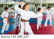 Serious girl practicing taekwondo movements in gym. Стоковое фото, фотограф Яков Филимонов / Фотобанк Лори