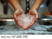 Washing hands with soap in a kitchen sink for hygiene and cleanliness. Мытье рук с мылом в кухонной раковине для поддержания гигиены и чистоты. Стоковое AI-изображение, AI-художник Katsiaryna Repich / Фотобанк Лори
