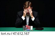 Contemplative gambler at poker table. Стоковое AI-изображение, AI-художник Андрей Бакусов / Фотобанк Лори