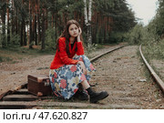 Teen Girl Reflecting on a Quiet Railway Surrounded by Nature in a Tranquil Moment. Стоковое фото, фотограф Aleksandr Golubev / Фотобанк Лори