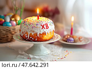 Пасхальный кулич с горящей свечой. Стоковое AI-изображение, AI-художник Щеголева Ольга / Фотобанк Лори