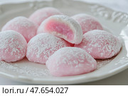 Delicious Japanese moti desserts. Close up. Asian rice daifuku dessert sweet mochi. Cut in half with filling. Traditional dessert mochi ice cream. Colorful rice cake. Fukashi manju. Culinary delights. Стоковое AI-изображение, AI-художник Марина Демидюк / Фотобанк Лори