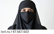 Woman in black attire with intense gaze presenting a powerful statement. Женщина в черном одеянии с напряженным взглядом, делающая мощное заявление. Стоковое AI-изображение, AI-художник Katsiaryna Repich / Фотобанк Лори