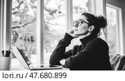 Introspective moment: A woman contemplates life by the window with laptop, captured in monochrome. Стоковое AI-изображение, AI-художник Данила Большаков / Фотобанк Лори