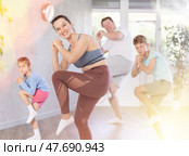 Parents with young daughter and schoolboy son are taught to move to boogie-woogie. Стоковое фото, фотограф Яков Филимонов / Фотобанк Лори
