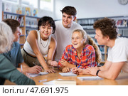 Team of diligent schoolkids during classes in library. Стоковое фото, фотограф Яков Филимонов / Фотобанк Лори