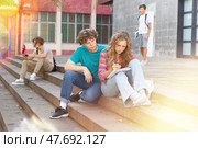 Teenage students preparing lessons together during recess. Стоковое фото, фотограф Яков Филимонов / Фотобанк Лори