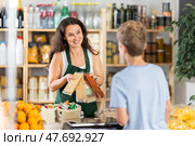 Female seller offers nougat to boy buyer. Стоковое фото, фотограф Яков Филимонов / Фотобанк Лори