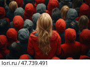 A woman with loose blond hair in a red jacket, standing among a crowd of people in hoods. Her face is hidden - she stands out not only because of her hairstyle, but also because she is facing away from the viewer, creating a powerful visual contrast with those around her. The atmosphere emphasizes the idea of ​​individuality, opposition and the search for one's identity in society. Ideal for the concepts of "being yourself", "standing out from the crowd", "unusual thinking", "uniqueness". Стоковое AI-изображение, AI-художник Анна Кривицкая / Фотобанк Лори