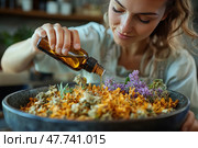 A young woman carefully pouring essential oil from an amber glass bottle onto a mixture of dried flowers and herbs in a deep ceramic bowl. The composition includes bright orange and purple plants, creating an atmosphere of coziness, naturalness and health care. The scene reflects moments of working with natural cosmetics, aromatherapy or phytotherapy. Natural lighting and soft focus emphasize organicity and harmony with nature. Стоковое AI-изображение, AI-художник Анна Кривицкая / Фотобанк Лори
