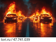 A dramatic scene on a night highway - many cars are engulfed in flames, burning cars are lined up in rows, flames rise high into the sky, and thick black smoke darkens the horizon. The asphalt glistens with the firelight, reflecting the terrifying flames. The scene conveys an atmosphere of chaos, destruction, disaster or a post-apocalyptic world. This image is ideal for illustrating themes of unrest, emergency situations, disasters, protests or artistic content. Стоковое AI-изображение, AI-художник Анна Кривицкая / Фотобанк Лори