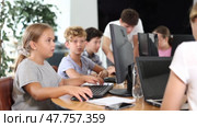 Concerned preteen girl and boy working together on computer in IT training room. Стоковое видео, видеограф Яков Филимонов / Фотобанк Лори