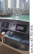 Dubai, UAE - 1 14 2023: Close-up of the captain's hands at the helm. He controls the movement of the yacht. S (2024 год). Редакционное видео, видеограф Aleksey Kidisyuk / Фотобанк Лори