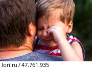 A little boy is crying while being in his father's arms, snuggling up to him to feel protected. Стоковое фото, фотограф Алина Лебедь / Фотобанк Лори
