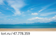 A wind turbine stands tall on a beach, harnessing energy from the ocean breeze. The turbine blade spins steadily, contributing to clean energy production. Стоковое AI-изображение, AI-художник Данила Большаков / Фотобанк Лори