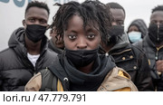 A group of african american individuals wearing protective face masks as a precautionary measure against the spread of viruses and germs. Стоковое AI-изображение, AI-художник Данила Большаков / Фотобанк Лори