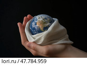 Human Hand Cradling Planet Earth Wrapped in Soft Cloth Symbolic Newborn Concept. Человеческая рука, держащая планету Земля, завернутую в мягкую ткань, символизирует концепцию новорожденного. Стоковое AI-изображение, AI-художник Katsiaryna Repich / Фотобанк Лори