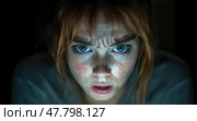 The expression on the young woman's face reveals her surprise and concern as she intently gazes at a screen in low light. Стоковое AI-изображение, AI-художник Данила Большаков / Фотобанк Лори