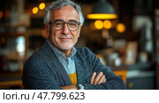 An older man with glasses stands confidently, smiling, in a warm cafe atmosphere filled with soft lighting. Стоковое AI-изображение, AI-художник Данила Большаков / Фотобанк Лори