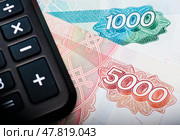 Калькулятор и купюры номиналом 1000 и 5000 рублей (крупный план) Стоковое фото, фотограф E. O. / Фотобанк Лори