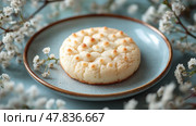 Delicious dessert on a blue plate surrounded by delicate flowers. Вкусное печенье на голубой тарелке в окружении нежных цветов. Стоковое AI-изображение, AI-художник Katsiaryna Repich / Фотобанк Лори