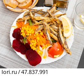 Dish with fried sardines, pilchards or anchovies in batter for traditional Spanish meal. Стоковое фото, фотограф Яков Филимонов / Фотобанк Лори