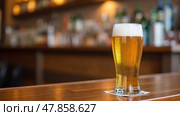 A Pint Glass Filled With Non-Alcoholic Beer Sits on a Polished Wooden Bar. Стоковое AI-изображение, AI-художник Sergey Grishin / Фотобанк Лори